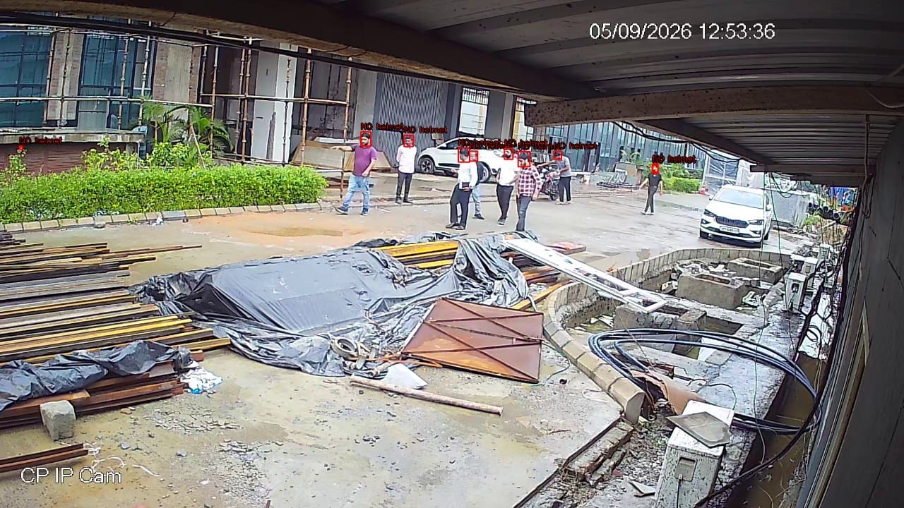 A construction site with several workers each boxed and labelled NO helmet